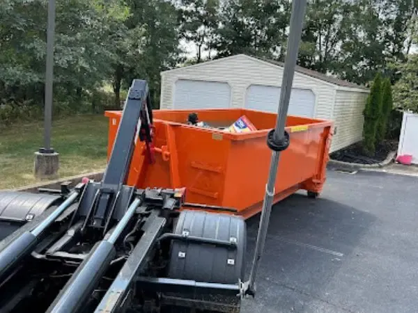 Orange dumpster in parking lot