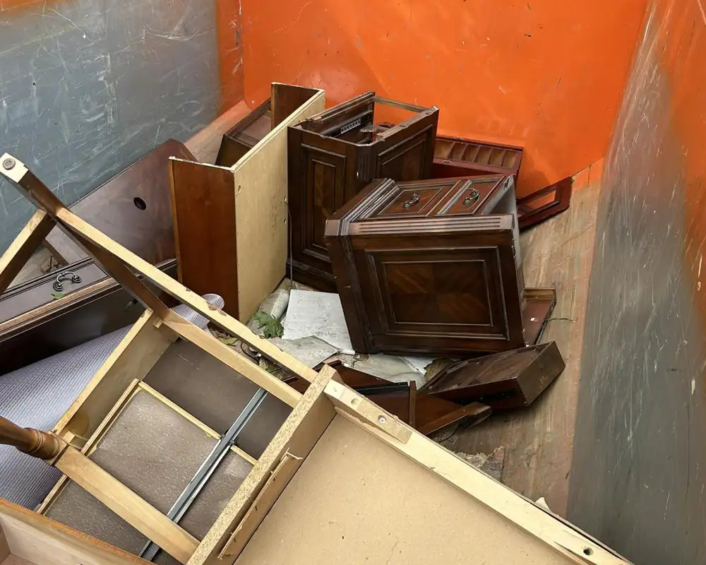 Cluttered dumpster with discarded furniture